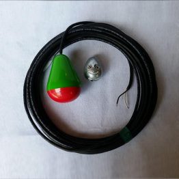 A green and red object sitting on top of a black cord.